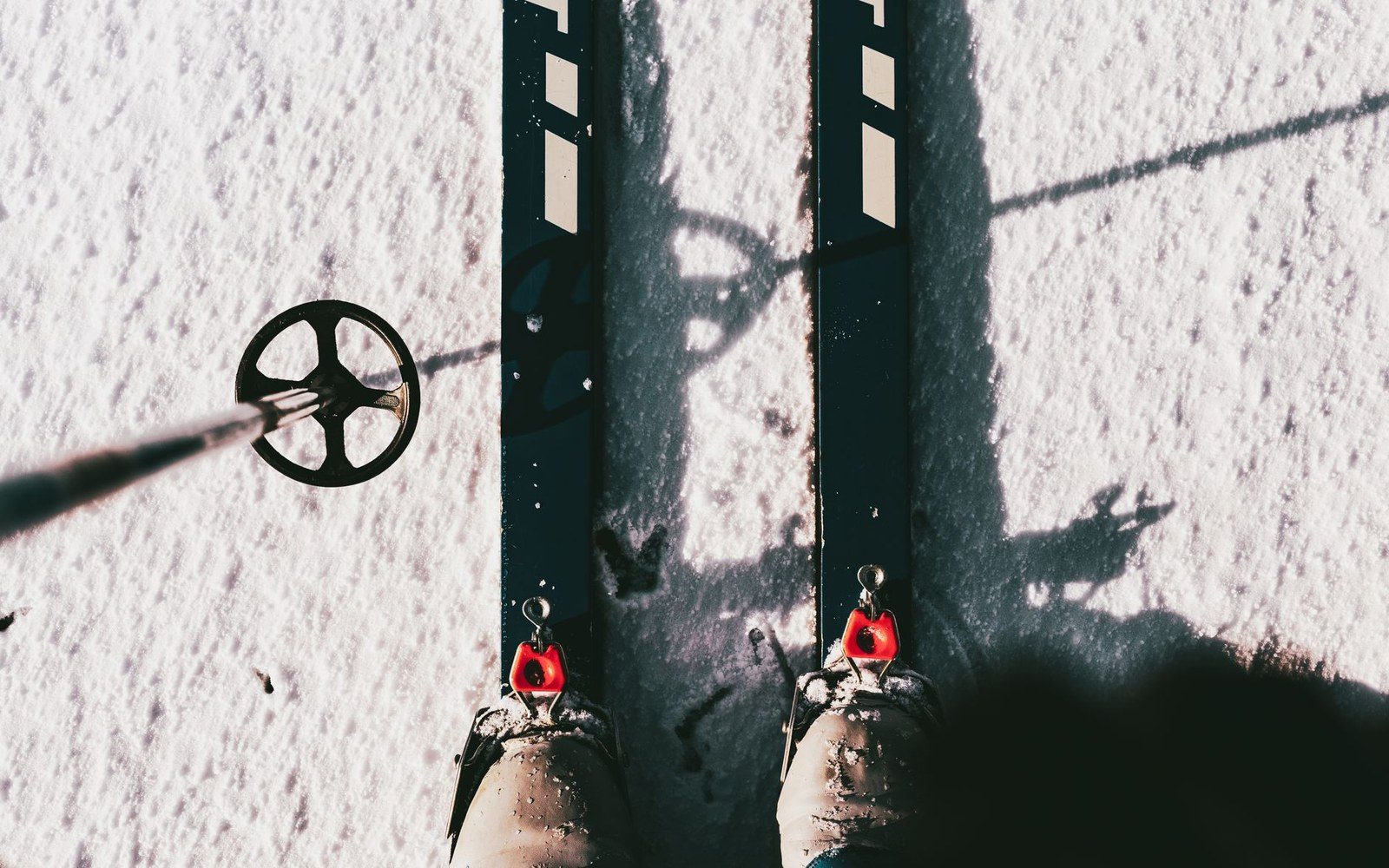 Skier's boots clipped into cross-country skis, viewed from above on snow